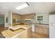 Functional kitchen features white appliances, wooden cabinets, and an island at 340 Loblolly Rdg, Locust Grove, GA 30248