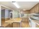 Functional kitchen features white appliances, wooden cabinets, and an island at 340 Loblolly Rdg, Locust Grove, GA 30248