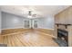 Bright living room features a fireplace and laminate wood flooring at 340 Loblolly Rdg, Locust Grove, GA 30248