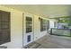 Inviting front porch features wood decking, decorative lattice, and a storm door at 340 Loblolly Rdg, Locust Grove, GA 30248