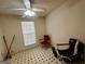 This cozy bedroom has natural light and a fun, tiled floor pattern at 955 Foxworthy Ln, Riverdale, GA 30296