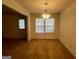 A bright dining room with natural light and an elegant chandelier at 955 Foxworthy Ln, Riverdale, GA 30296