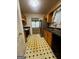 Galley-style kitchen featuring tile flooring, ample cabinetry, and modern appliances at 955 Foxworthy Ln, Riverdale, GA 30296