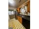 Well-lit kitchen featuring a stainless steel refrigerator and view to dining area at 955 Foxworthy Ln, Riverdale, GA 30296