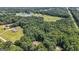 A wooded lot with a modest home tucked in the trees and sports fields located within a short distance at 207 Conkle Rd, Hampton, GA 30228