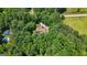 A lovely home surrounded by a dense forest and a private driveway leading up to the residence at 207 Conkle Rd, Hampton, GA 30228