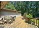 Relax on this back deck with a table and wooded views, perfect for outdoor dining and entertaining in a natural setting at 207 Conkle Rd, Hampton, GA 30228