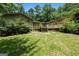 Home featuring a backyard deck and mature trees at 207 Conkle Rd, Hampton, GA 30228