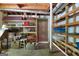 Unfinished basement area with wooden shelving units for ample storage at 207 Conkle Rd, Hampton, GA 30228