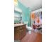 Bright bathroom featuring a vanity sink, toilet, and shower with a floral patterned curtain, showcasing fun style at 207 Conkle Rd, Hampton, GA 30228