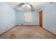 Bright bedroom featuring a ceiling fan, carpeted floors, with natural light streaming through the windows at 207 Conkle Rd, Hampton, GA 30228