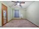 Bedroom featuring a ceiling fan, carpeted floors, with natural light streaming through the window at 207 Conkle Rd, Hampton, GA 30228