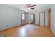 Neutral bedroom featuring wood-look flooring, ceiling fan, and closet at 207 Conkle Rd, Hampton, GA 30228