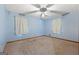 Bright bedroom featuring a ceiling fan, carpeted floors, with natural light streaming through the windows at 207 Conkle Rd, Hampton, GA 30228