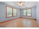 Bedroom with hardwood floors, natural light from two large windows, and neutral walls at 207 Conkle Rd, Hampton, GA 30228
