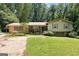 Charming single-Gathering home featuring a well-manicured lawn, mature trees, and inviting curb appeal at 207 Conkle Rd, Hampton, GA 30228