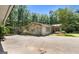 Ranch home featuring an open driveway, covered parking and mature trees at 207 Conkle Rd, Hampton, GA 30228