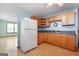 Cozy kitchen with wooden cabinets, laminate countertops, and a white refrigerator at 207 Conkle Rd, Hampton, GA 30228