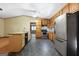 A cozy kitchen with stone floors, wood cabinets and stainless steel appliances at 207 Conkle Rd, Hampton, GA 30228