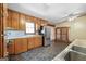 A cozy kitchen with stone floors, wood cabinets and stainless steel appliances at 207 Conkle Rd, Hampton, GA 30228