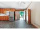 A cozy kitchen with stone floors, wood cabinets and stainless steel appliances at 207 Conkle Rd, Hampton, GA 30228