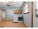 Convenient laundry area with washer, dryer, and upper cabinets at 207 Conkle Rd, Hampton, GA 30228
