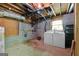 Unfinished basement laundry area featuring washer and dryer hookups and storage at 207 Conkle Rd, Hampton, GA 30228