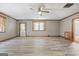 Spacious living room with wood-look flooring, ceiling fan, and natural light at 207 Conkle Rd, Hampton, GA 30228