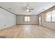 Bright living room featuring wood-look floors, painted brick wall, and natural light at 207 Conkle Rd, Hampton, GA 30228