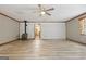 Large living room with wood-look flooring, fireplace, and brick accent wall at 207 Conkle Rd, Hampton, GA 30228