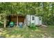 Backyard shed with covered storage area in a lush, green backyard at 207 Conkle Rd, Hampton, GA 30228