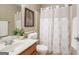Cozy bathroom with vanity, sink, toilet, shower, and decorative shower curtain at 286 Prominent Loop, Mcdonough, GA 30253