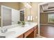 Bathroom with double sinks, vanity, and an open door to the main bedroom at 286 Prominent Loop, Mcdonough, GA 30253