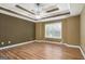 Spacious bedroom featuring a ceiling fan, decorative trey ceiling, and wood flooring at 286 Prominent Loop, Mcdonough, GA 30253
