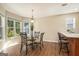 Bright dining area featuring a glass table, pendant lighting, and a view to the outside at 286 Prominent Loop, Mcdonough, GA 30253