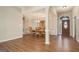 Open-concept dining room with wood floors, a decorative hutch, and natural light at 286 Prominent Loop, Mcdonough, GA 30253
