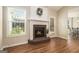 Charming fireplace with a brick hearth, white mantel, and an adjacent door to the outside at 286 Prominent Loop, Mcdonough, GA 30253