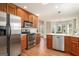 Well-lit kitchen features stainless steel appliances, breakfast nook, and wood cabinets at 286 Prominent Loop, Mcdonough, GA 30253