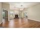 Cozy living room featuring wood floors, a brick fireplace and a view to the backyard at 286 Prominent Loop, Mcdonough, GA 30253