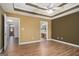 Spacious bedroom features a ceiling fan, trey ceiling, wood flooring, and attached bathroom at 286 Prominent Loop, Mcdonough, GA 30253