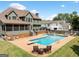 Beautiful backyard with a swimming pool, patio, screened in porch, and lush lawn offers relaxation at 5585 Lavender Farms, Powder Springs, GA 30127