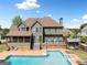 Inviting backyard with a sparkling pool, deck, screened porch, and playhouse, ideal for outdoor enjoyment at 5585 Lavender Farms, Powder Springs, GA 30127