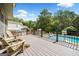 Backyard deck with a pool and outdoor grill, ideal for relaxation and entertaining at 5585 Lavender Farms, Powder Springs, GA 30127