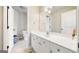 Bathroom features white cabinets, tile floors, and a large mirror at 5585 Lavender Farms, Powder Springs, GA 30127
