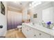 Bathroom features white cabinets, tile floors, a large mirror and shower at 5585 Lavender Farms, Powder Springs, GA 30127