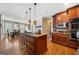 Open concept kitchen with granite countertops, stainless steel appliances, and rich wood cabinets at 5585 Lavender Farms, Powder Springs, GA 30127