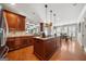 Spacious kitchen with a center island, granite countertops, stainless steel appliances, and rich wooden cabinetry at 5585 Lavender Farms, Powder Springs, GA 30127