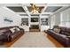 Cozy living room featuring hardwood floors, a fireplace, built-in shelving, and comfortable leather sofas at 5585 Lavender Farms, Powder Springs, GA 30127
