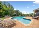 Backyard swimming pool with lounge chairs and lush landscaping for ultimate relaxation at 5585 Lavender Farms, Powder Springs, GA 30127