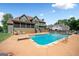 Backyard pool featuring a diving board, plenty of room for lounge chairs, and lovely landscaping at 5585 Lavender Farms, Powder Springs, GA 30127